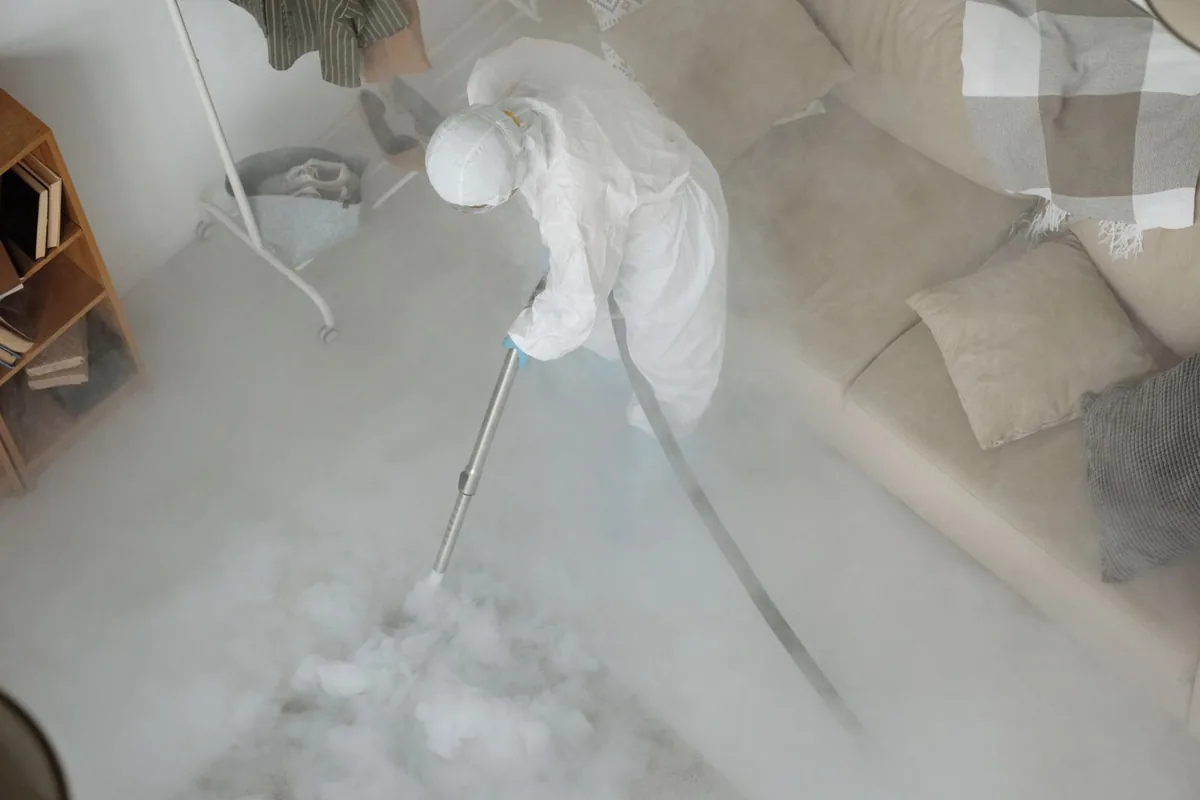 Biohazard cleanup technician in protective equipment, Bellville, TX